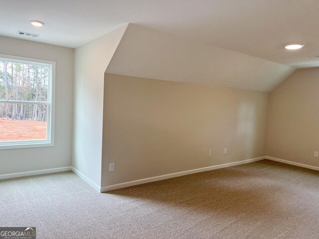 bonus room featuring baseboards, visible vents, lofted ceiling, and carpet flooring