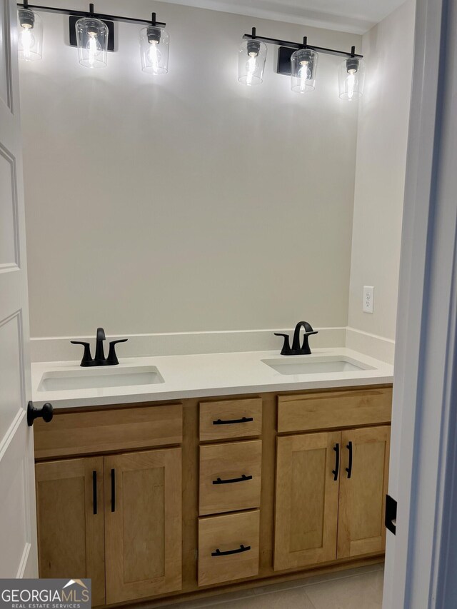 bathroom with double vanity, a sink, and tile patterned flooring