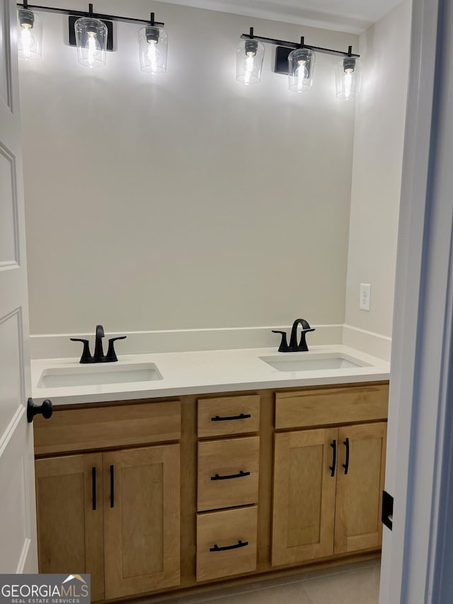 bathroom featuring double vanity, tile patterned flooring, and a sink