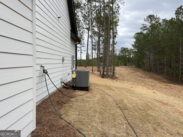 view of yard featuring central air condition unit