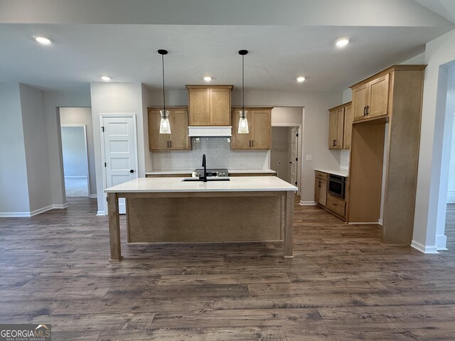 kitchen featuring dark wood-type flooring, a sink, custom range hood, built in microwave, and backsplash