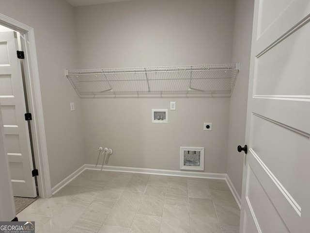 laundry area with hookup for a washing machine, hookup for an electric dryer, baseboards, and laundry area