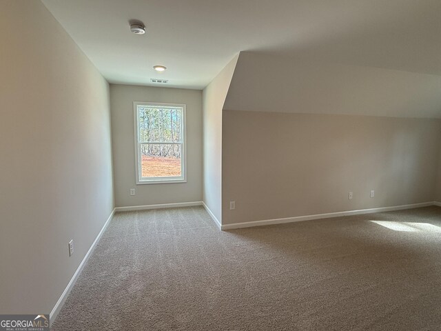 bonus room featuring baseboards, visible vents, and carpet