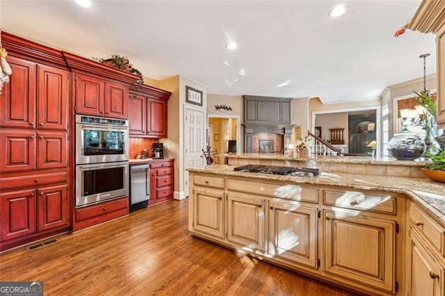 kitchen featuring pendant lighting, stainless steel appliances, and dark wood-type flooring