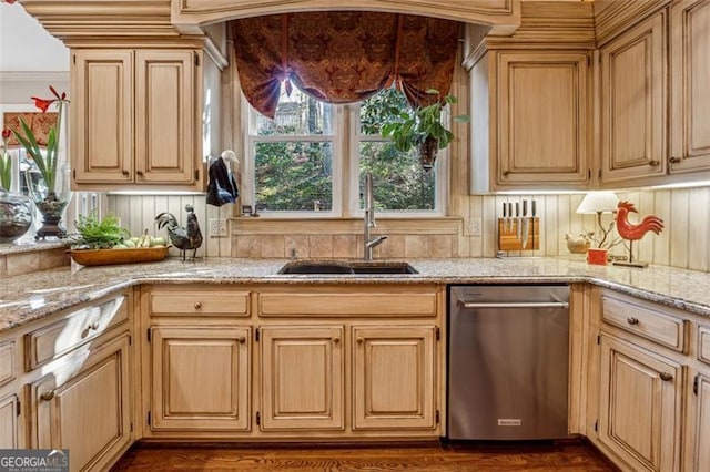 kitchen with decorative backsplash, light stone counters, sink, and stainless steel dishwasher