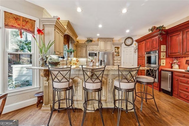 kitchen with light stone countertops, a center island, dark wood-type flooring, and appliances with stainless steel finishes