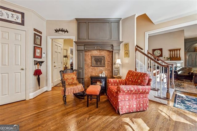 sitting room featuring ornamental molding and hardwood / wood-style flooring