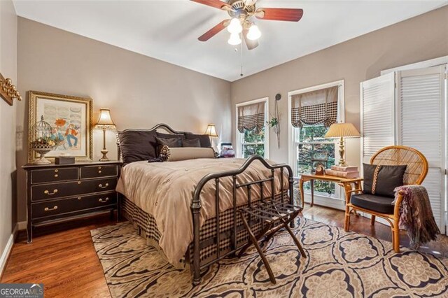 bedroom featuring hardwood / wood-style floors and ceiling fan