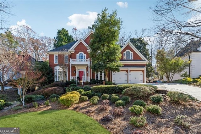 view of front of property with a balcony, a front lawn, and a garage