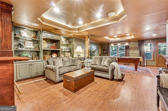 interior space featuring a raised ceiling, built in shelves, light hardwood / wood-style floors, and pool table