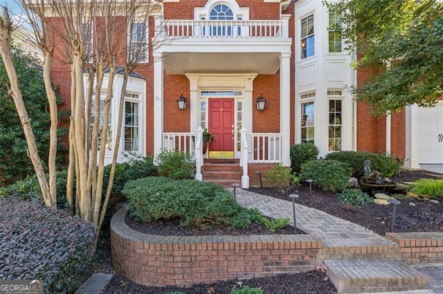 property entrance featuring a garage and a balcony