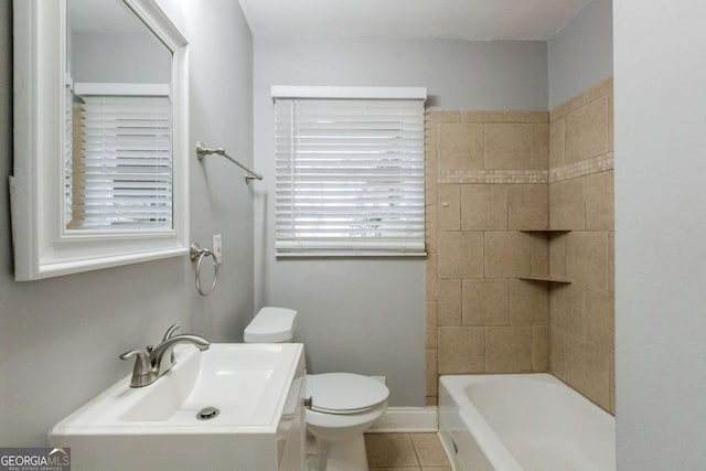 bathroom featuring sink, tile patterned flooring, and toilet