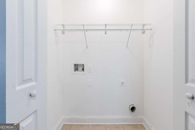 laundry area featuring electric dryer hookup, light tile patterned floors, and washer hookup