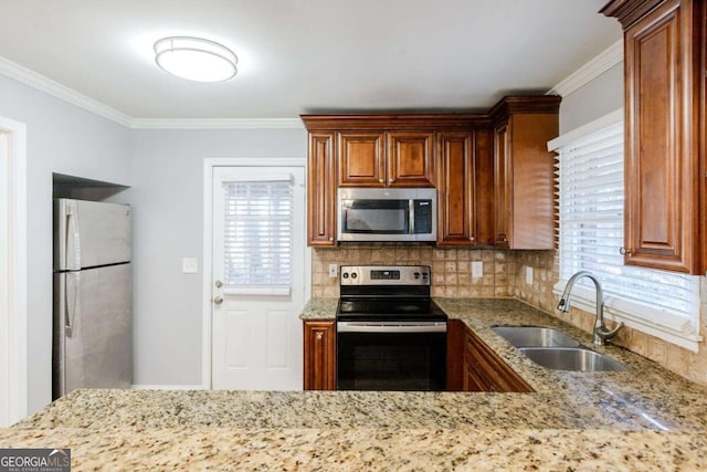 kitchen featuring light stone countertops, sink, backsplash, crown molding, and appliances with stainless steel finishes