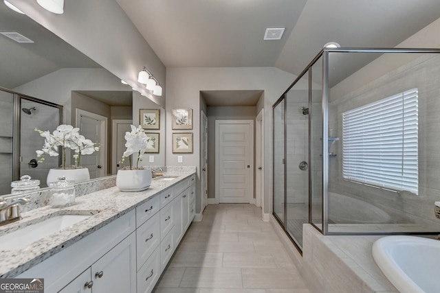 bathroom with tile patterned floors, vanity, independent shower and bath, and vaulted ceiling