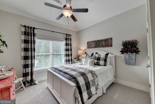 carpeted bedroom with ceiling fan and vaulted ceiling