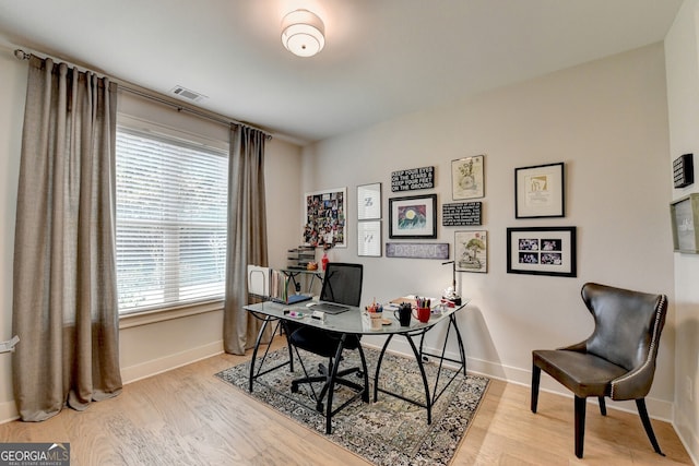 office space with light hardwood / wood-style floors and a wealth of natural light