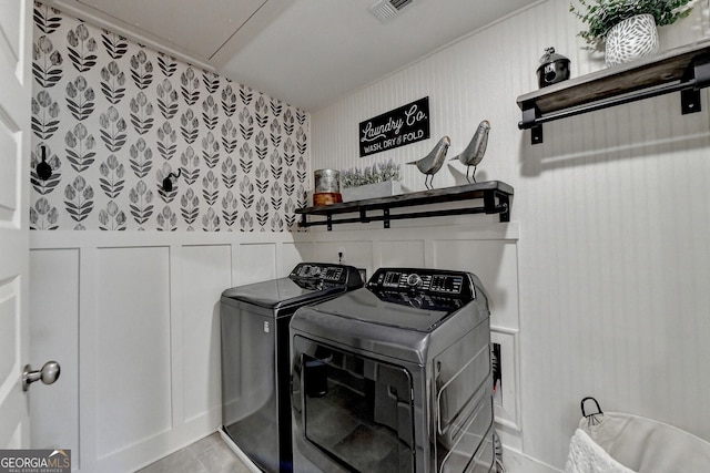 laundry area featuring washer and clothes dryer and light tile patterned floors