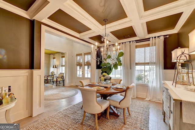 dining space with crown molding, light hardwood / wood-style flooring, beamed ceiling, and coffered ceiling