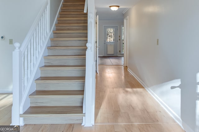 stairs featuring hardwood / wood-style flooring