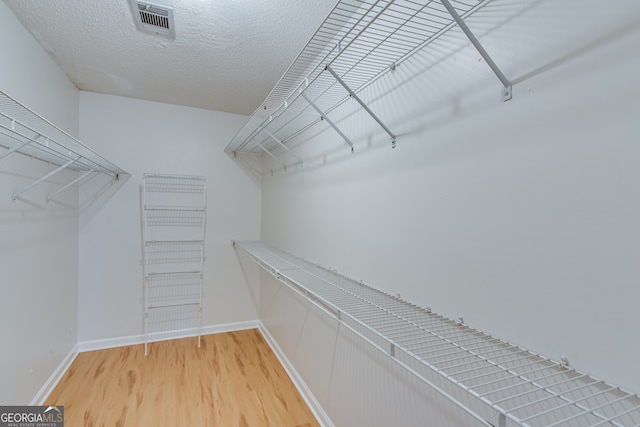 spacious closet featuring hardwood / wood-style floors