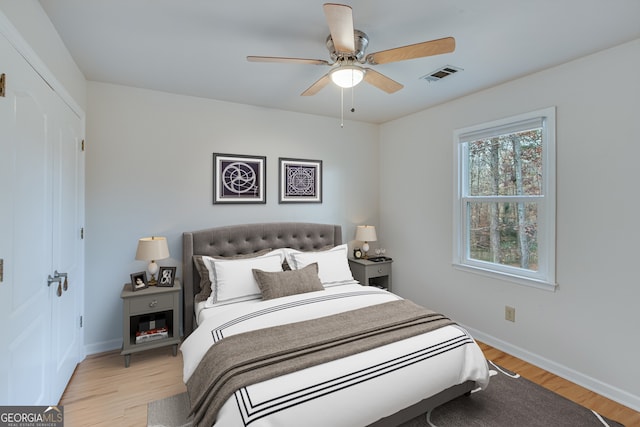 bedroom with ceiling fan and light hardwood / wood-style flooring