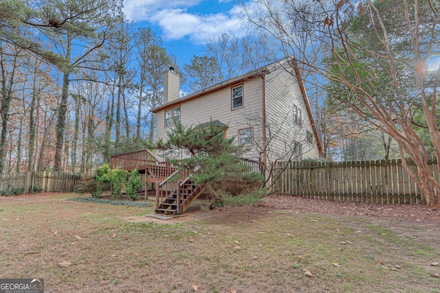 exterior space featuring a deck and a lawn