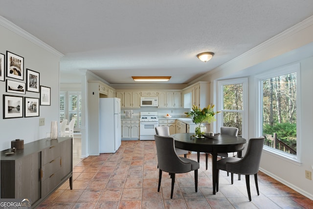 tiled dining space with a textured ceiling and ornamental molding