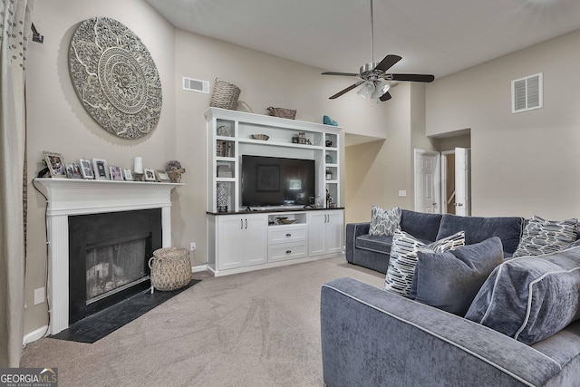 carpeted living room featuring ceiling fan