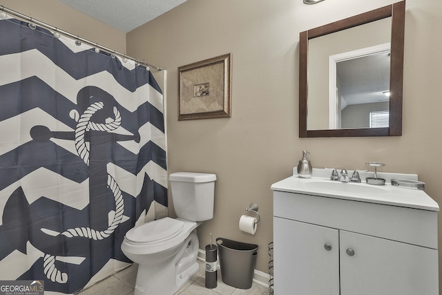 bathroom with tile patterned floors, vanity, toilet, and a textured ceiling