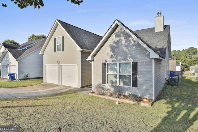 view of front of house featuring a garage and a front lawn