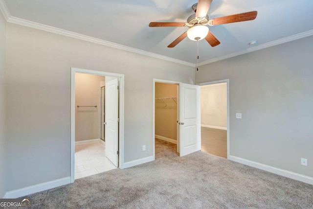 3770 Shades Valley Ln, Gainesville, GA 30501 - unfurnished bedroom featuring ceiling fan, crown molding, a walk in closet, light carpet, and a closet