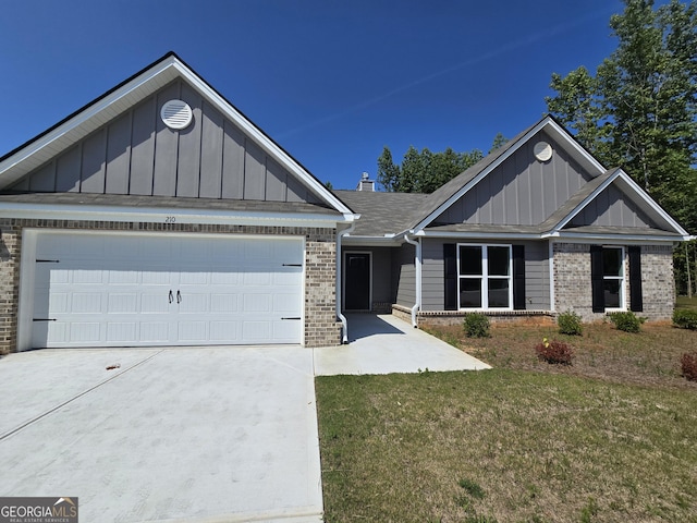 210 Hummingbird Ln Unit 08, Statham, GA 30666 - view of front of home featuring board and batten siding, brick siding, a garage, concrete driveway, and a front lawn