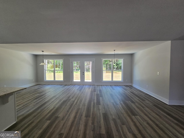 210 Hummingbird Ln Unit 08, Statham, GA 30666 - unfurnished living room with dark wood-style flooring, plenty of natural light, and a chandelier
