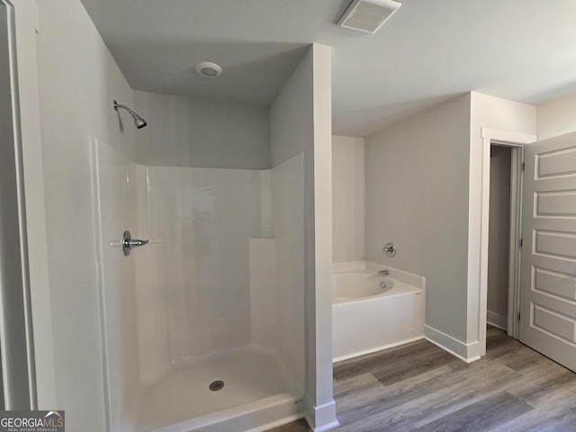 210 Hummingbird Ln Unit 08, Statham, GA 30666 - full bathroom featuring wood finished floors, a garden tub, and a shower