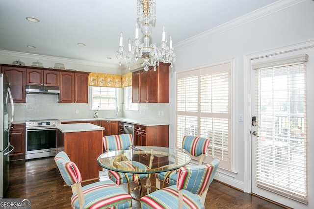 kitchen with appliances with stainless steel finishes, a center island, dark wood-type flooring, and backsplash