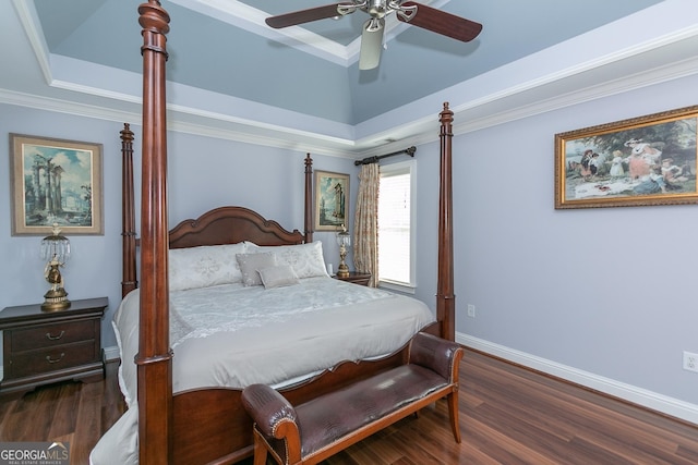 bedroom with ceiling fan, dark hardwood / wood-style flooring, ornamental molding, and a tray ceiling