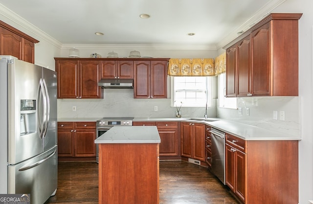 kitchen featuring a center island, sink, appliances with stainless steel finishes, tasteful backsplash, and dark hardwood / wood-style flooring