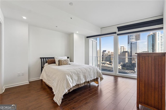 bedroom featuring access to exterior and dark hardwood / wood-style floors