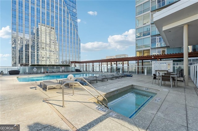 view of pool featuring a community hot tub and a patio