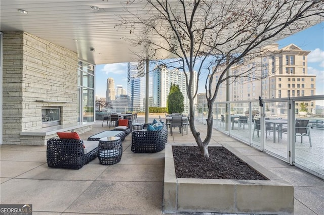 view of patio / terrace featuring an outdoor living space with a fireplace