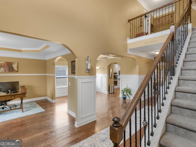 interior space featuring hardwood / wood-style flooring and crown molding