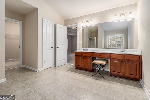 bathroom featuring tile patterned floors, a shower with door, vanity, and lofted ceiling