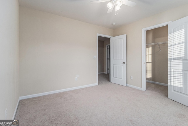 unfurnished bedroom with ceiling fan, light carpet, and a closet