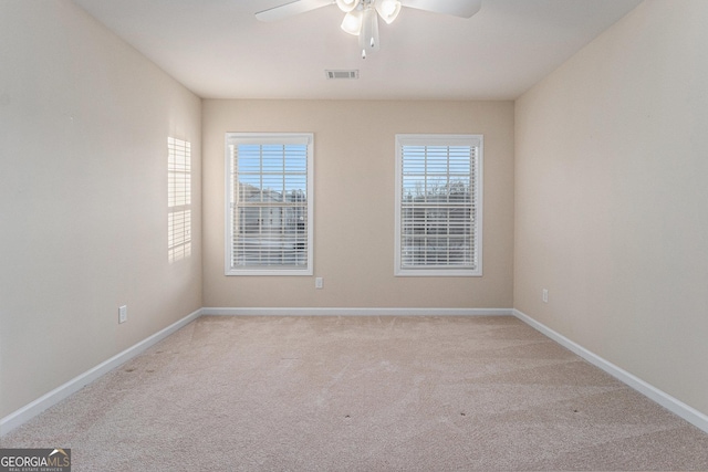 spare room with light carpet and ceiling fan