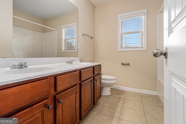 bathroom featuring toilet, vanity, and tile patterned floors