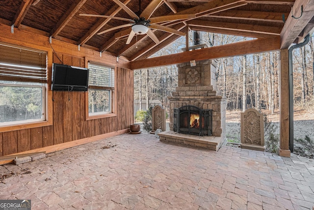 view of patio / terrace featuring an outdoor stone fireplace and ceiling fan