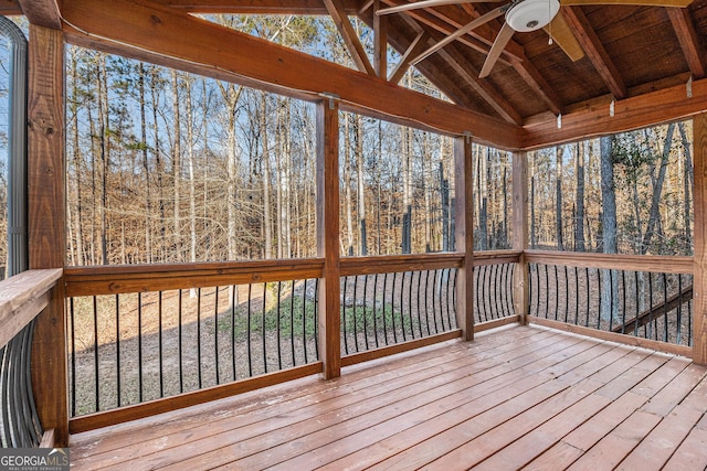 unfurnished sunroom featuring vaulted ceiling with beams, ceiling fan, and wood ceiling