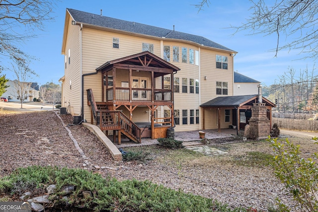 rear view of house with central AC unit and a patio area