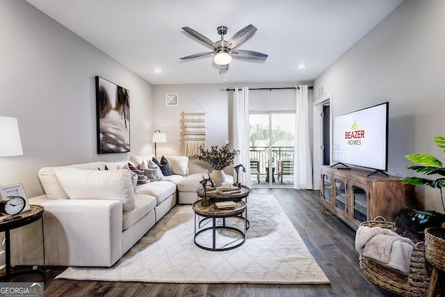 living room with wood-type flooring and ceiling fan